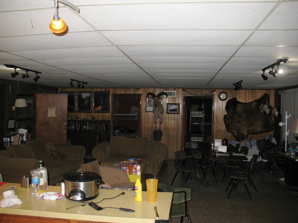The camp living area with mounts on the wall and supper laid out on the table
